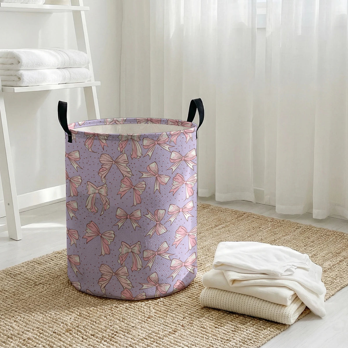 A purple canvas laundry basket with an elegant pink bow pattern sitting on a woven rug.