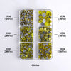 A clear plastic tray containing various sizes of yellow and silver citrine glass rhinestones for crafting.