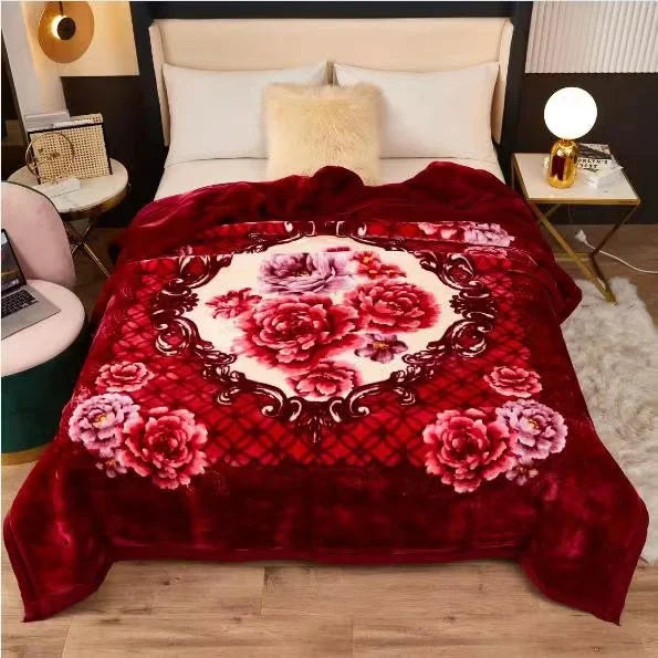 A deep red plush fleece blanket featuring a large floral pattern of pink and white roses on a light beige background.