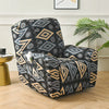 A black and beige geometric floral print slipcover set for a recliner or sofa placed on a wooden floor.
