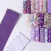 A collection of floral cotton fabric rolls in various colors and patterns for quilting and crafting.
