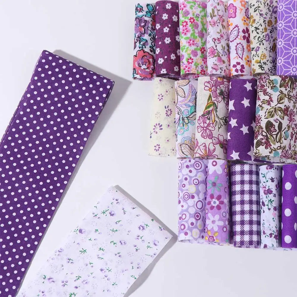 A collection of floral cotton fabric rolls in various colors and patterns for quilting and crafting.
