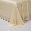 A smooth, beige luxury Egyptian cotton bed sheet draped elegantly on a surface.