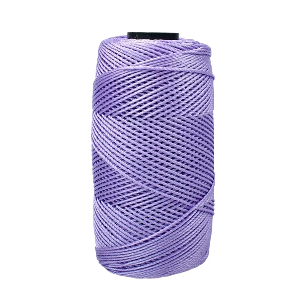 A spool of purple 1.5mm cotton silk thread for knitting and crafting.
