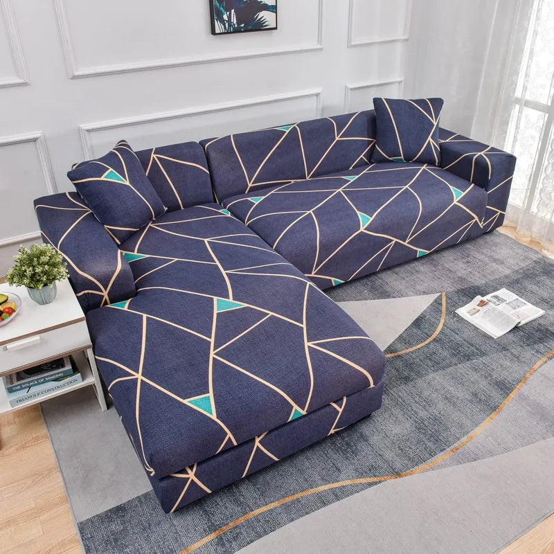A navy blue L-shaped sofa protector cover featuring a geometric pattern with teal accents on a light gray rug.