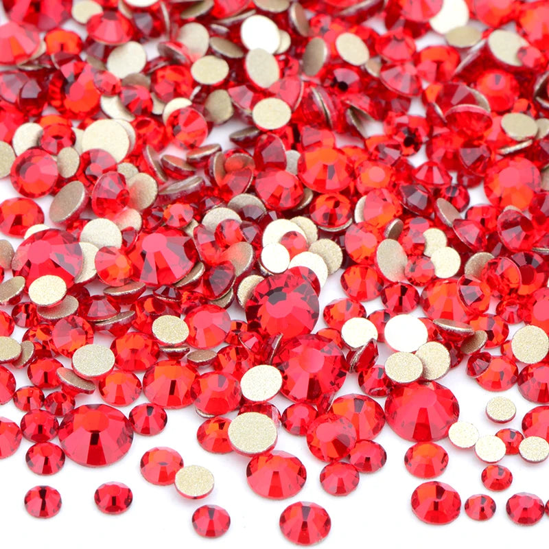 A pile of red and gold clear glass rhinestones for DIY crafts