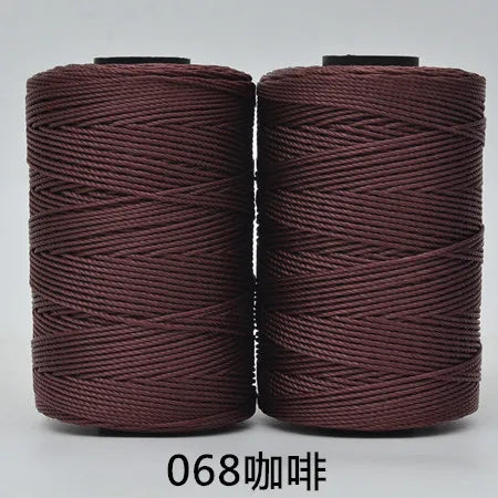 Two spools of dark reddish-brown hand knitting and crochet cord for crafting