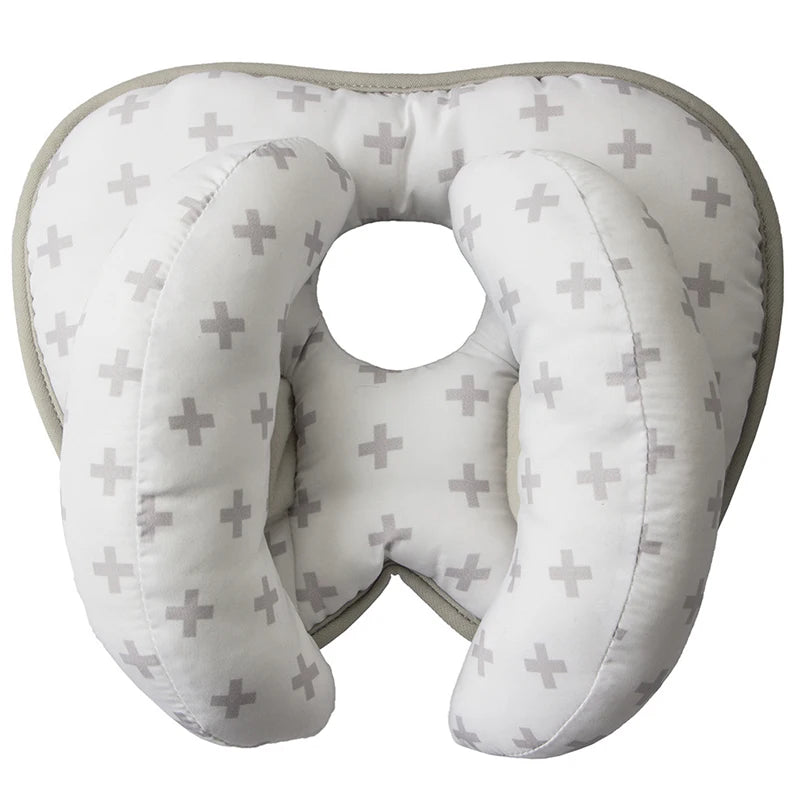 A white baby head and neck support pillow designed for use in strollers and car seats.