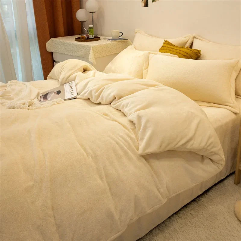 A bed with a luxurious cream flannel duvet cover set and pillows in a bright bedroom.