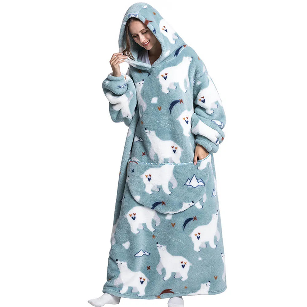 A woman wearing a light blue sherpa fleece oversized blanket hoodie with a hood and large pocket.