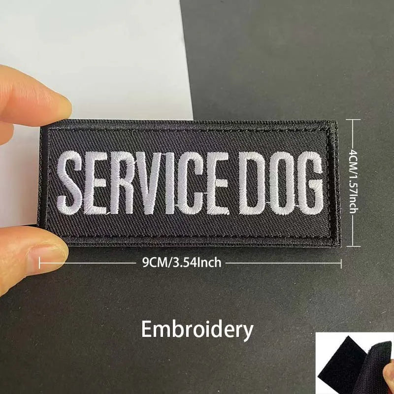 Black embroidered patch with white text SERVICE DOG on a dark background