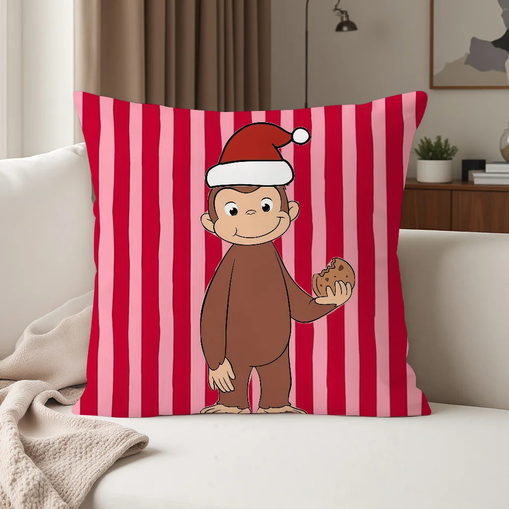 A decorative pillow cover featuring a cartoon monkey wearing a Santa hat against a red and pink striped background.