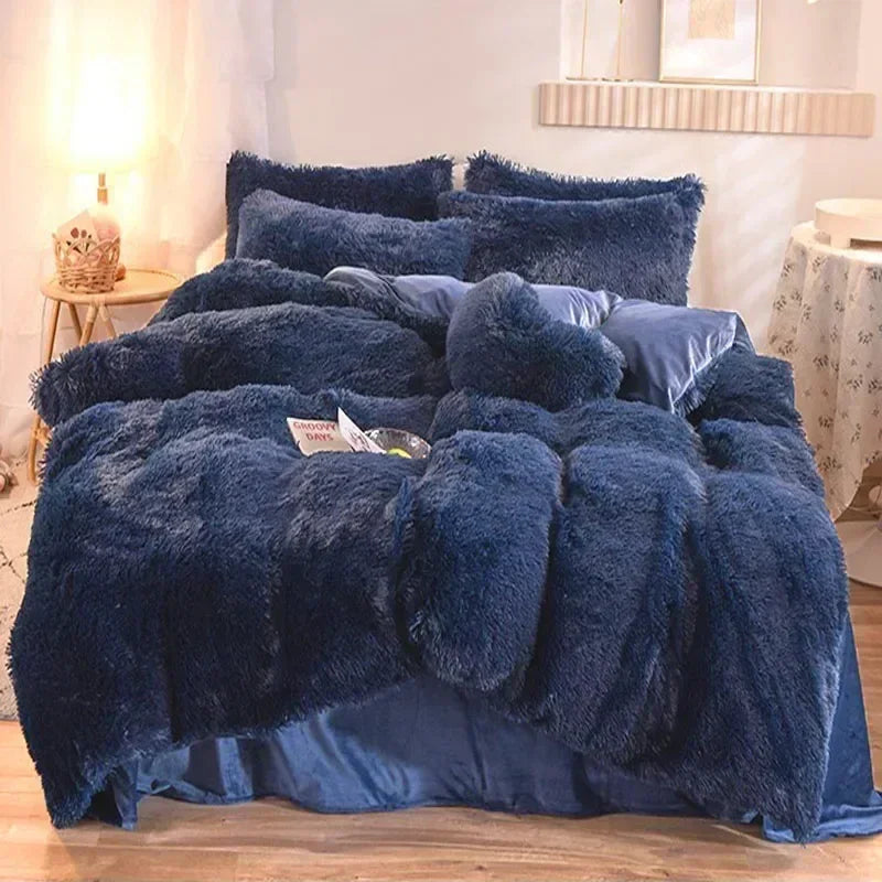 A dark blue plush mink velvet duvet set spread on a bed with white and gray decor.
