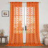 Orange pompom jacquard sheer curtain hanging in a glass door frame.