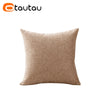 A square beige linen cushion cover with a button closure.