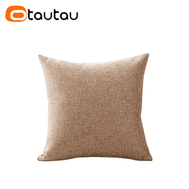 A square beige linen cushion cover with a button closure.