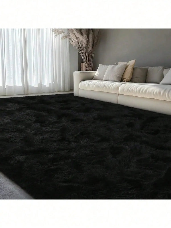 A dark gray plush long-pile area rug placed in a modern living room with sheer white curtains and a light sofa.