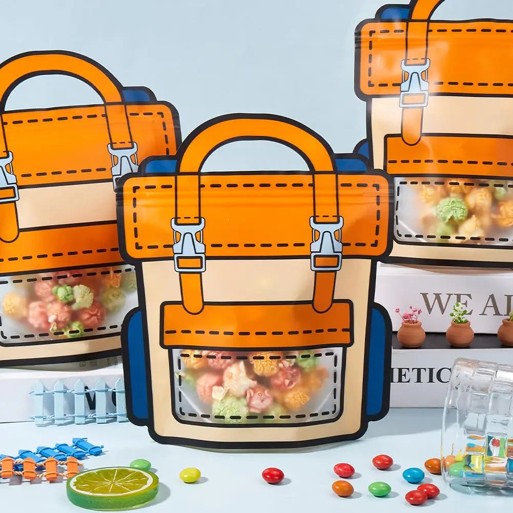 Orange and blue cartoon goodie bags with clear pockets and orange handles displayed on a white surface.