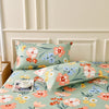 A floral fitted sheet set with pillowcases featuring pink, orange, and blue flowers on a light green background.