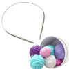Stainless steel circular knitting needles with various colored yarn balls inside a container