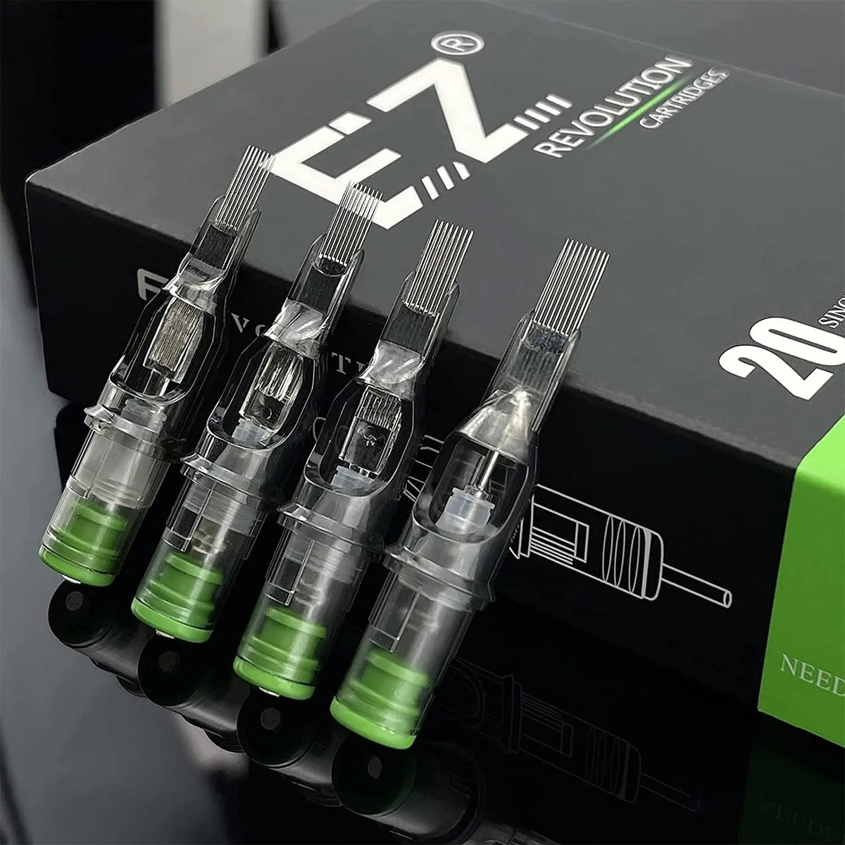 A box of EZ Revolution cartridges for Magnum Tattoo needles shown with several individual cartridges displayed below.
