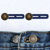 A pair of brass buttons with the brand name on them are shown next to a denim jean pocket.
