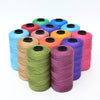 A collection of hand knitting and crochet cord in various colors including blue, green, yellow, orange, pink, and purple.