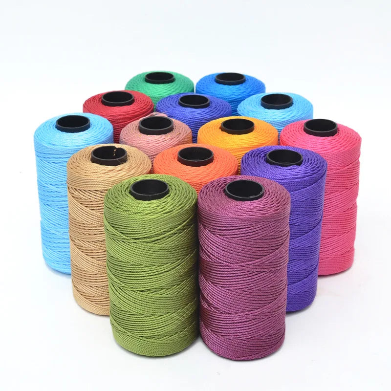 A collection of hand knitting and crochet cord in various colors including blue, green, yellow, orange, pink, and purple.