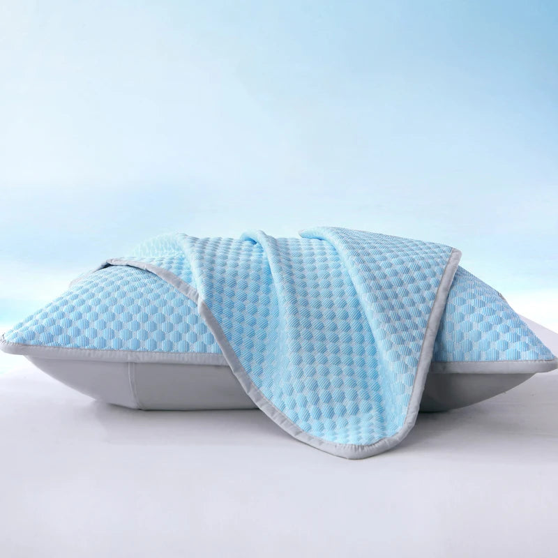 Light blue quilted cooling bean pillow cover resting on a white surface.