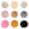 A collection of round faux fur sheepskin rugs in various shades including beige, pink, gray, and black.