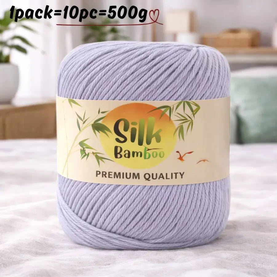 A skein of light purple silk bamboo blend yarn is shown on a white surface.
