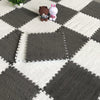 A gray and white checkered play mat with soft plush bear and rabbit toys placed on the surface.