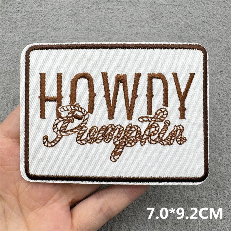 A square embroidered patch featuring the text HOWDY Pumpkin
