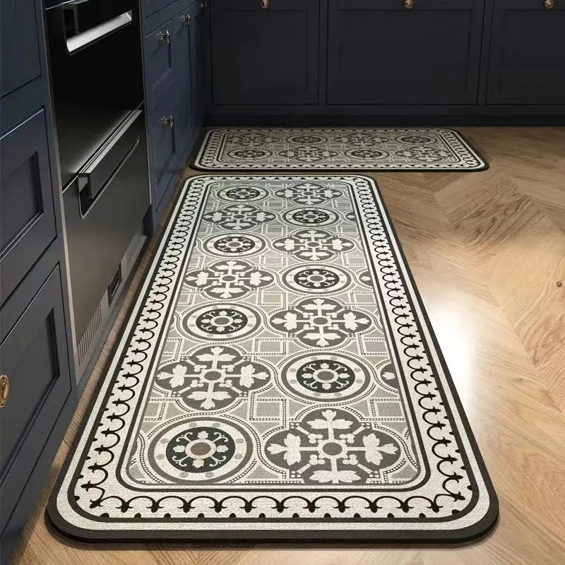 A long rectangular floor mat with a gray and black geometric pattern placed on a wooden floor next to dark cabinetry.