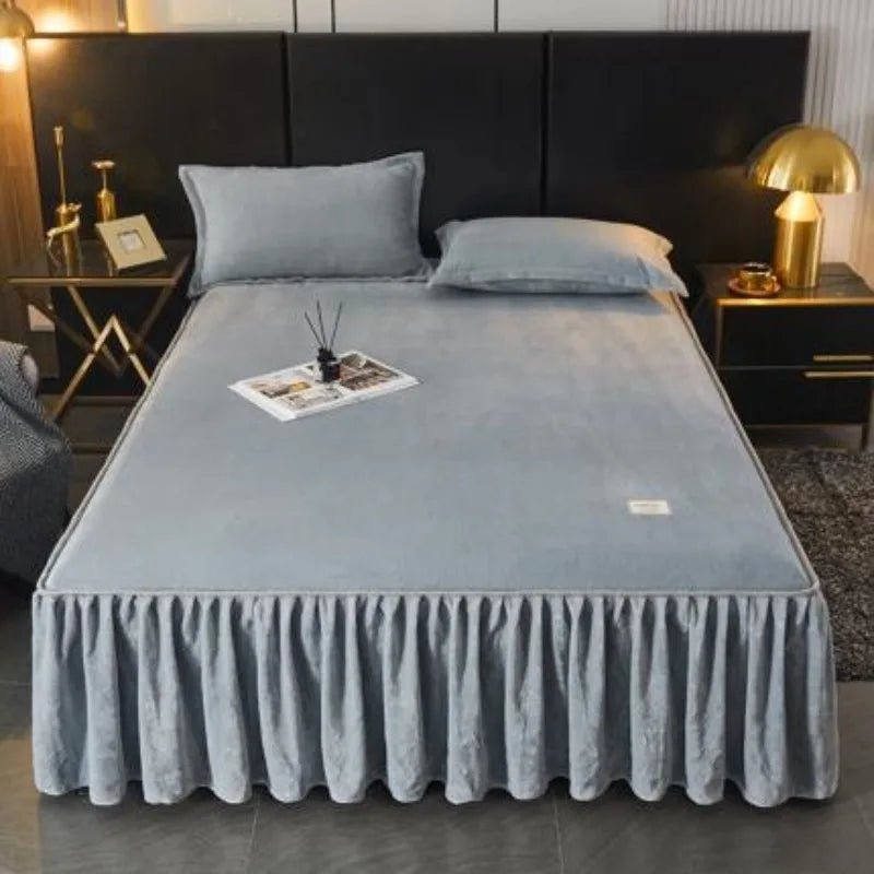 A thick milk velvet bed skirt with a ruffled hem is displayed on a bed in a modern bedroom setting.