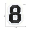 A black embroidered number 8 patch with white felt backing and a white border.