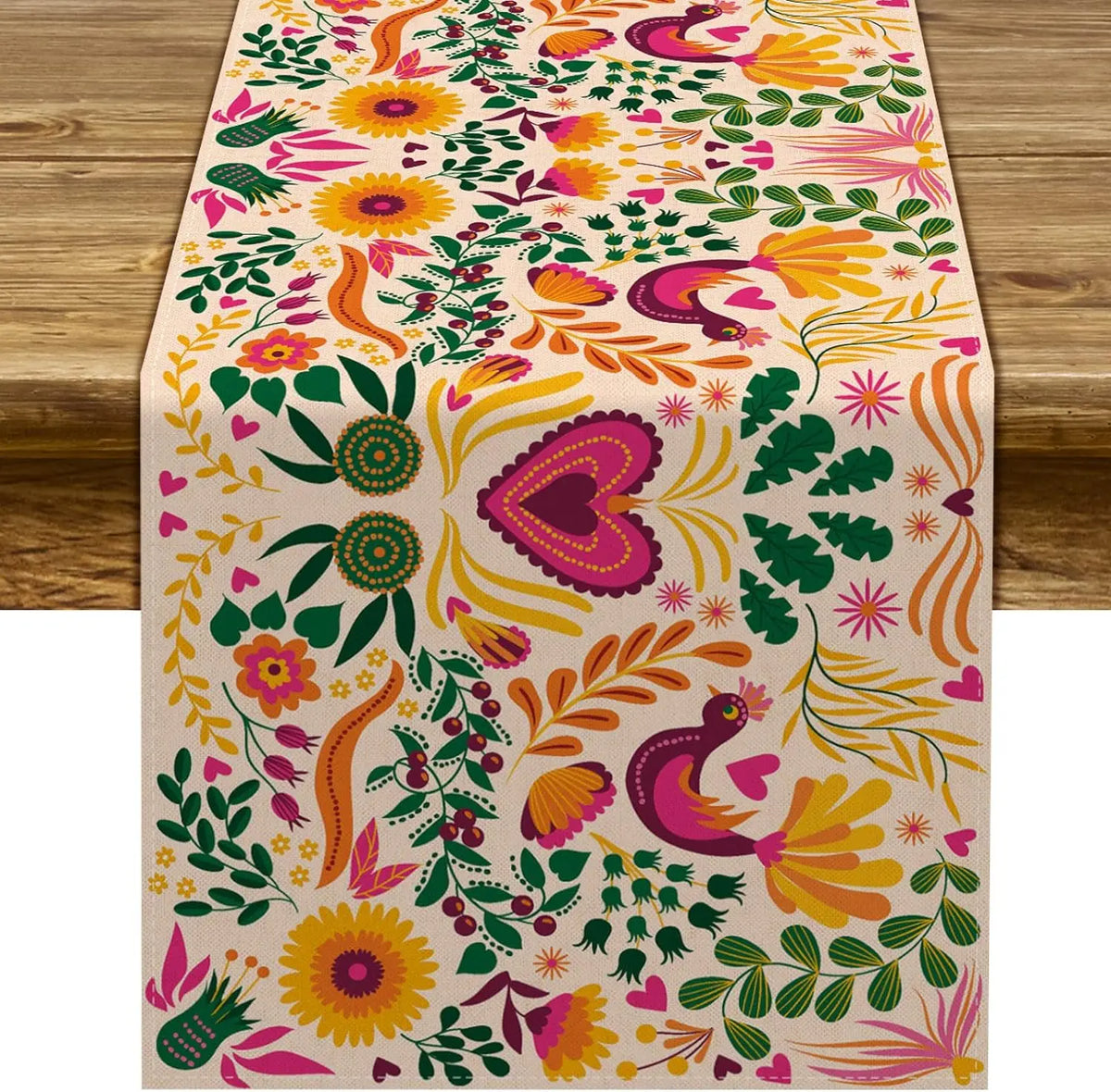 A linen table runner featuring a vibrant floral pattern in shades of pink, yellow, orange, and green.