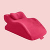 A bright pink memory foam wedge pillow shown from the side against a light background.