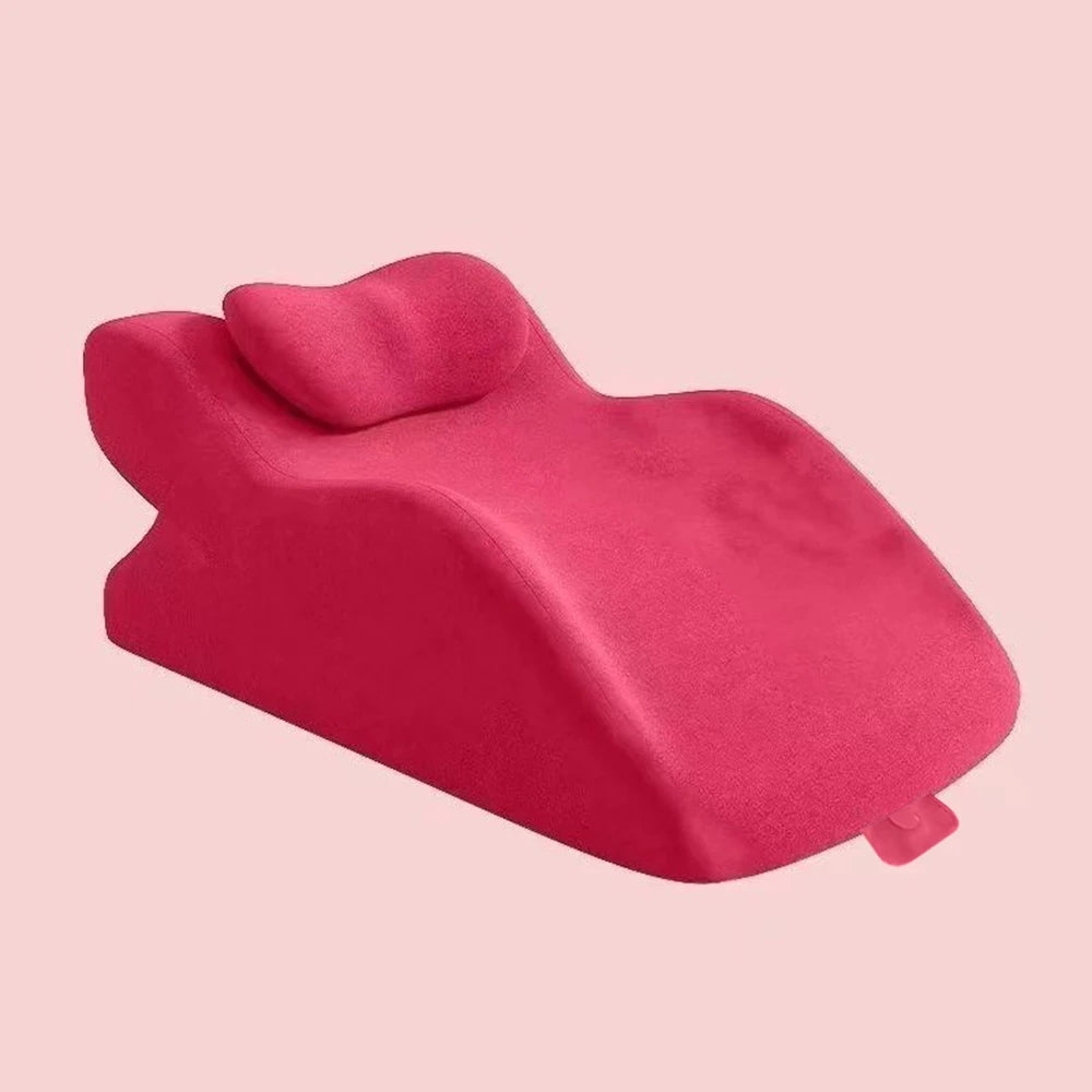 A bright pink memory foam wedge pillow shown from the side against a light background.