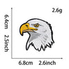 A black and white embroidery patch depicting an eagle head with yellow eyes and beak.