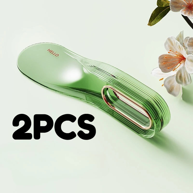 Two green silicone mattress lifters or bed linen organizers are shown on a light green surface.