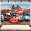 A backdrop featuring various cartoon race cars celebrating a happy birthday with mountains in the background.