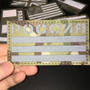 A hand holds a tactical multicam national flag patch with Cyrillic text and horizontal stripes.