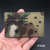 A dark green and brown camouflage patch featuring a stylized Union Jack design with stars.