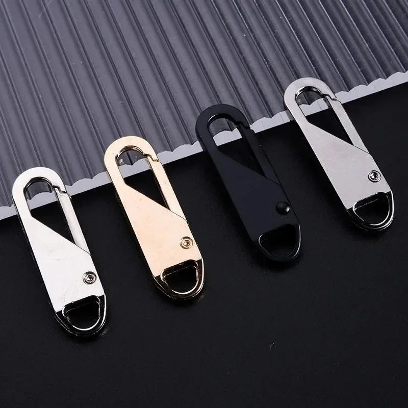 A set of universal replacement zipper pullers in silver and gold colors displayed on a dark surface.