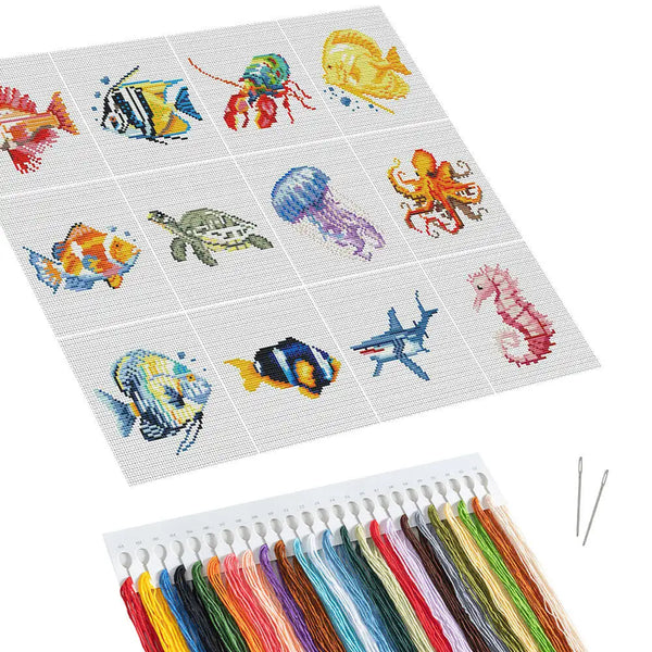 A cross stitch kit featuring various fish and sea creatures in colorful embroidery thread.