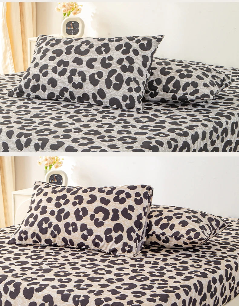 A set of leopard print decorative pillow covers in black and gray on a bed.