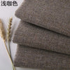 Stack of coarse linen and cotton fabric rolls in a muted gray color