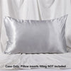 A smooth, silver satin pillowcase is displayed against a white fabric background.