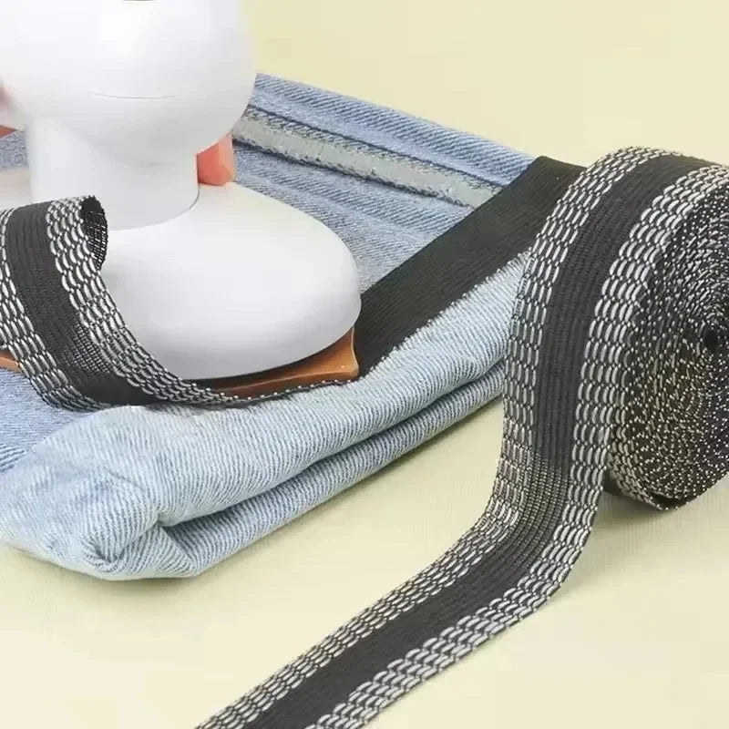 A roll of black and white iron-on hem tape is shown next to a white mannequin head.